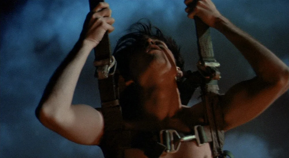 Freddy’s Dead: The Final Nightmare (1991) movie still: medium — A dark night sky fills the background behind a person suspended in mid-air. The…