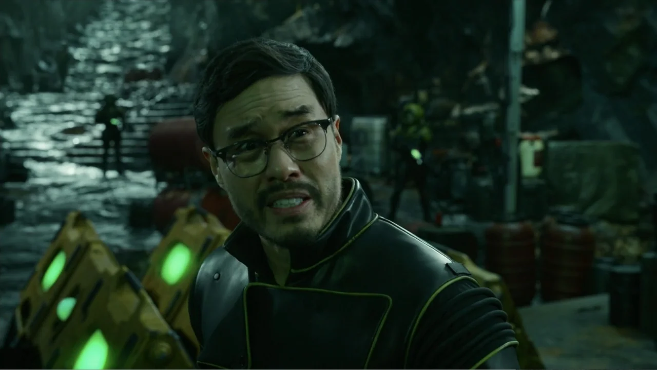 Aquaman and the Lost Kingdom (2023) movie still: medium — An underground industrial bunker with dark stone walls and scattered glowing green…
