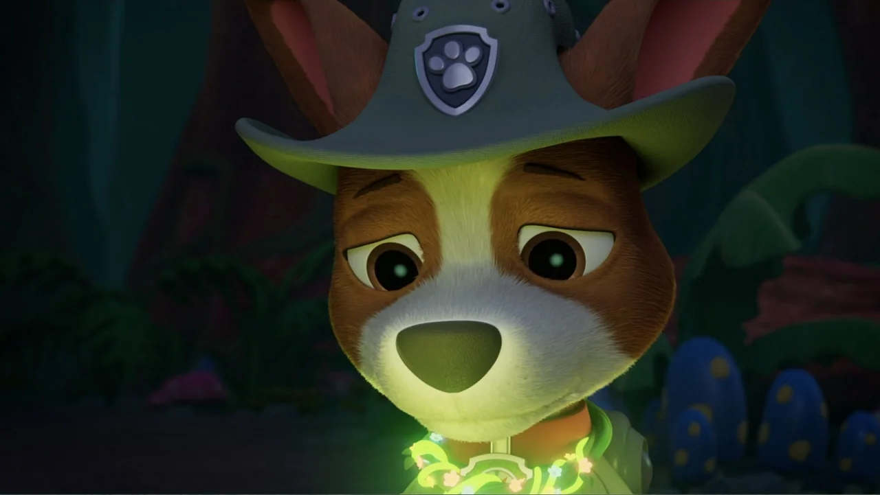 Valiente: A Tracker Story (2025) movie still: closeup — An anthropomorphic puppy stands in a dimly lit, shadowy woodland environment at night. The…