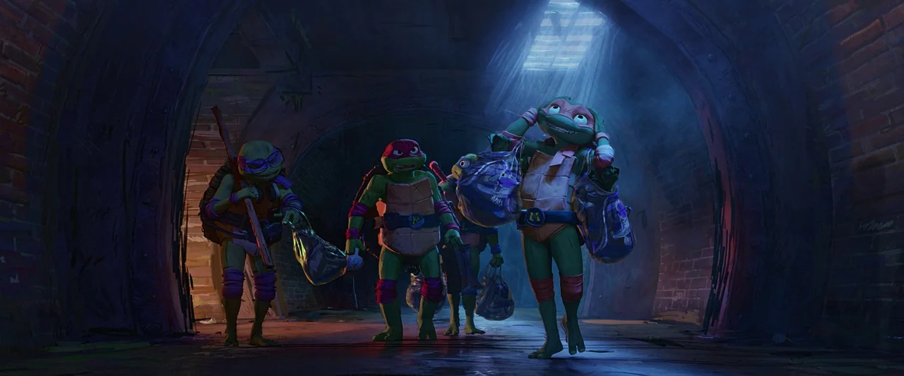 Teenage Mutant Ninja Turtles: Mutant Mayhem (2023) movie still: wide — Four anthropomorphic turtles walk through a dark, arched subterranean brick…
