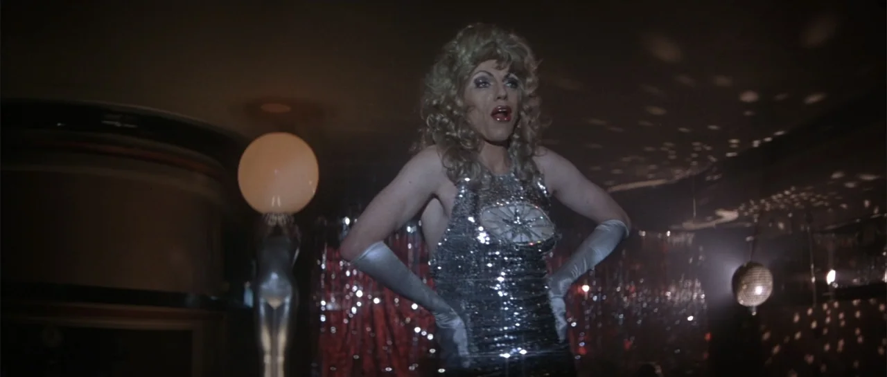 The Adventures of Priscilla, Queen of the Desert (1994) movie still: medium — A dimly lit lounge with reflective silver decor and a small stage…