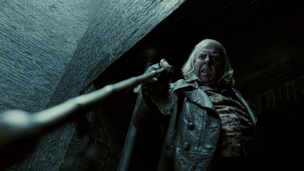 Sweeney Todd: The Demon Barber of Fleet Street (2007) movie still: medium — A dark brick-walled urban setting illuminated by sharp, low-key…