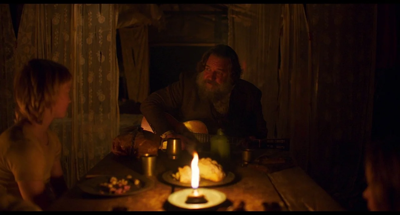 True History of the Kelly Gang (2019) movie still: medium — A dimly lit interior space features white lace curtains hanging within a confined…