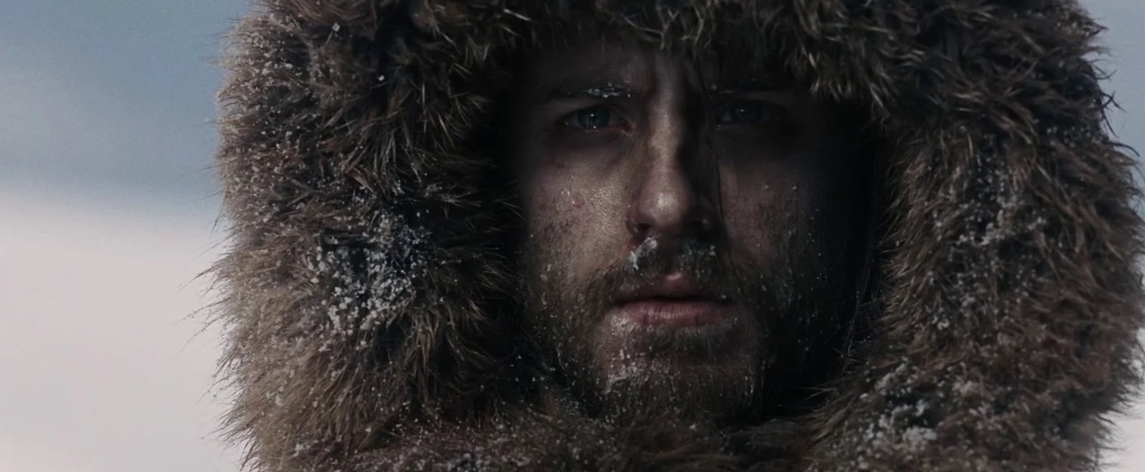 30 Days of Night (2007) movie still: closeup — A snowy tundra landscape provides the backdrop for a rugged outdoorsman in extreme cold. The man…