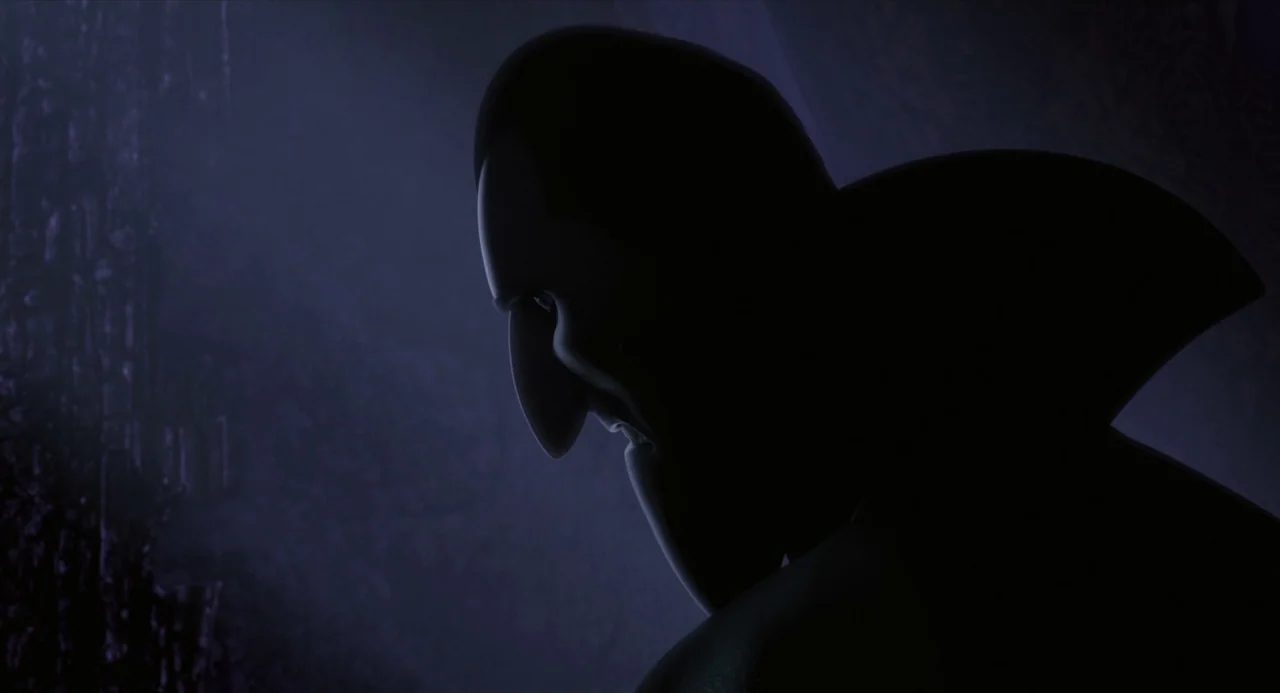 Hotel Transylvania movie still: closeup — A dark, dimly lit gothic space with textured wall surfaces in the deep background. A silhouette of a man…
