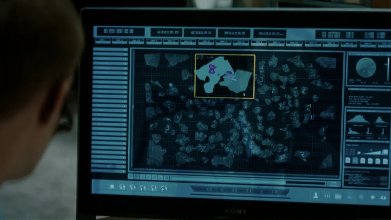 The Tourist (2010) movie still: medium — A dimly lit room focuses on a computer monitor displaying complex digital data. The screen shows a…