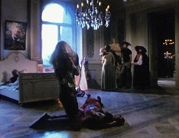 The Niklashausen Journey (1970) movie still: fullbody — A spacious, high-ceilinged room with ornate molding, a chandelier, and a large arched…