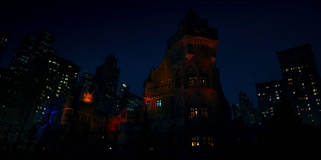 Polar (2019) movie still: establishing — A dark gothic stone mansion stands amidst a modern dense metropolitan skyline at night. Warm light glows…