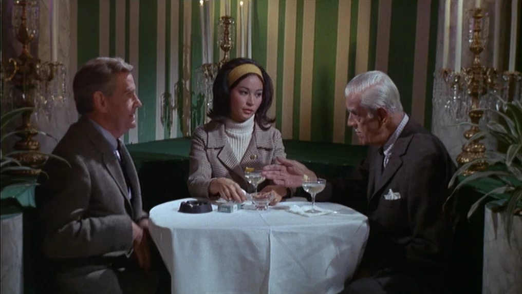 Targets (1968) movie still: medium — A restaurant booth features green and white striped wallpaper and gold-trimmed crystal lamps. Two men and one…