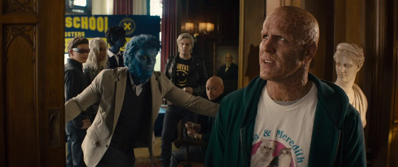 Deadpool 2 (2018) movie still: medium — A wood-paneled mansion interior with classic architectural details and a bust of a statue. A bald man with…