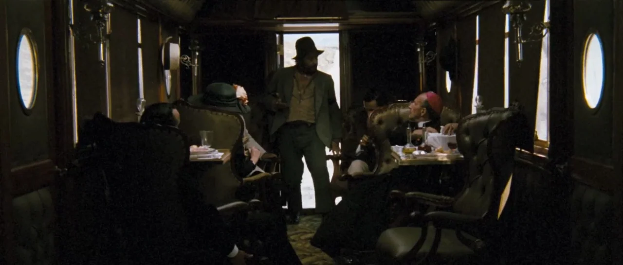 Duck, You Sucker (1971) movie still: wide — An opulent, dimly lit nineteenth-century train car with leather chairs and oval windows. A bearded man…