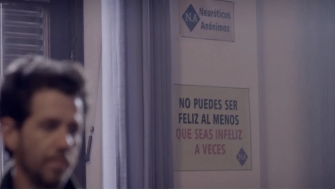Heaven Sent (1994) movie still: medium — A plain interior wall features a posted sign for a support group. A man is visible out of focus in the left…