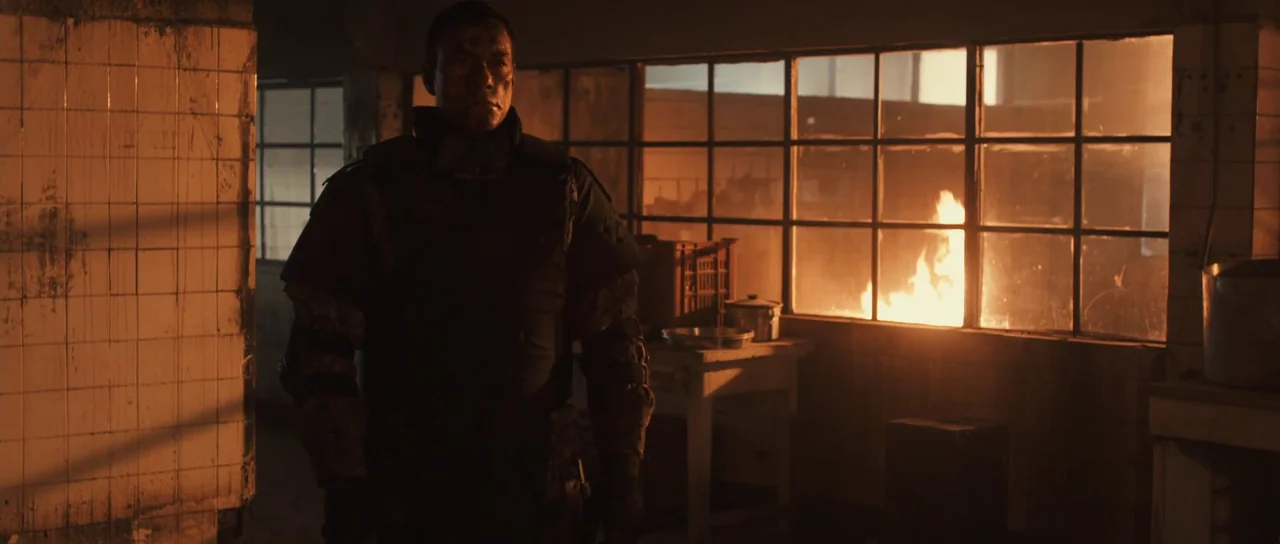 Universal Soldier: Regeneration (2009) movie still: medium — An industrial kitchen with white tiled walls is illuminated by intense orange…