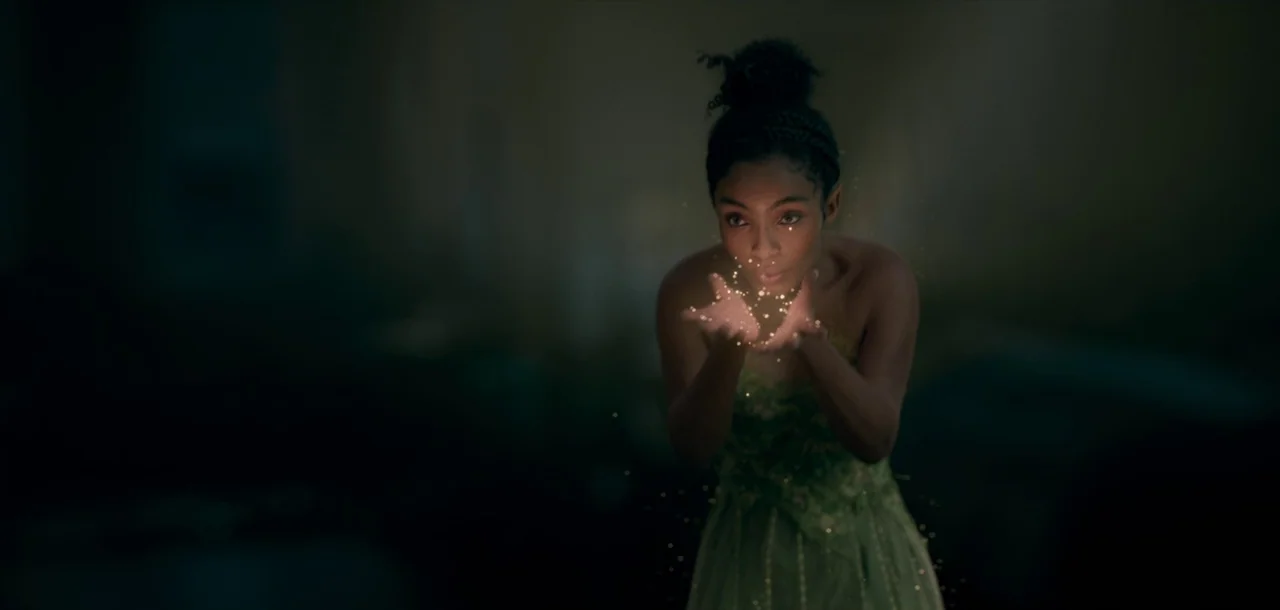 Peter Pan & Wendy (2023) movie still: medium — A woman stands in a dark and empty space surrounded by shadows. She holds out her hands and releases…