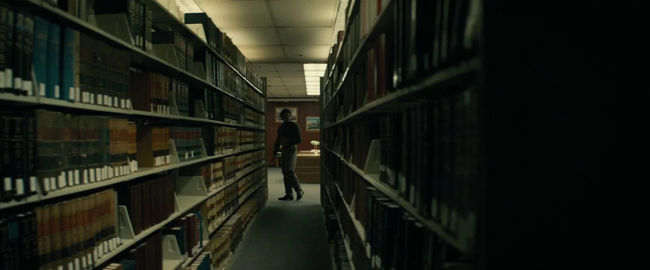 Extremely Wicked, Shockingly Evil and Vile (2019) movie still: wide — A narrow aisle flanked by tall metal shelves packed with leather-bound legal…