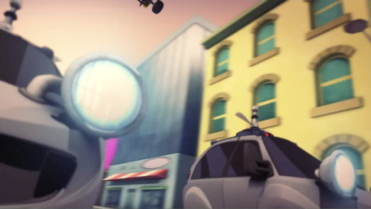 Team Hot Wheels: The Skills to Thrill (2015) movie still: wide — A city street features stylized yellow buildings and modern gray vehicles under a…