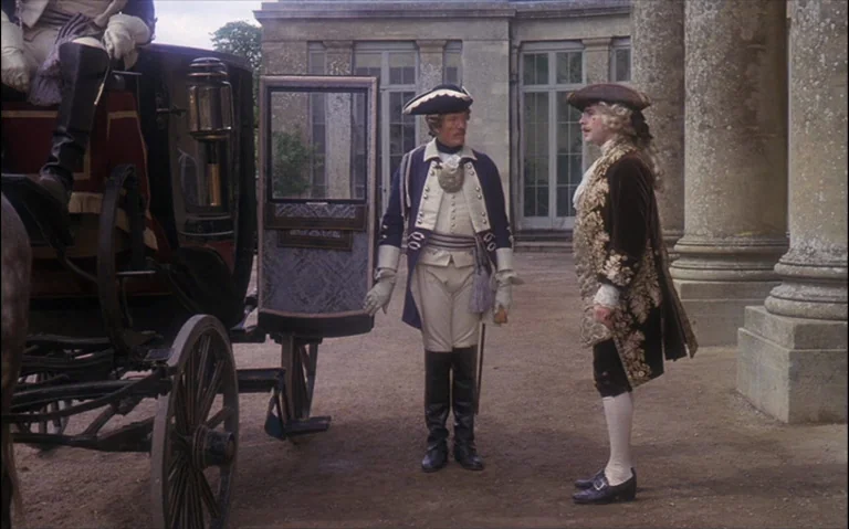 Barry Lyndon (1975) movie still: fullbody — A stone-paved courtyard sits before a large building with classical columns and glass doors. Two men in…