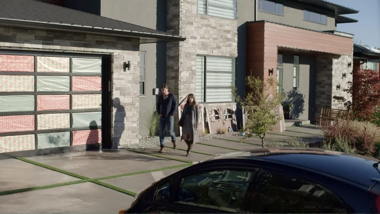 Always and Forever Christmas (2019) movie still: fullbody — A modern two-story suburban house features stone siding, wooden accents, and garage…