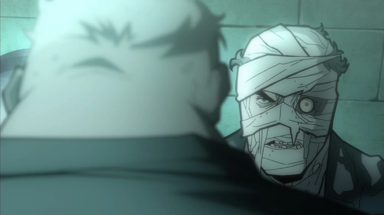 Batman: The Long Halloween, Part Two (2021) movie still: medium — A dimly lit industrial cell features a tiled wall with a greenish glow. A bandaged…