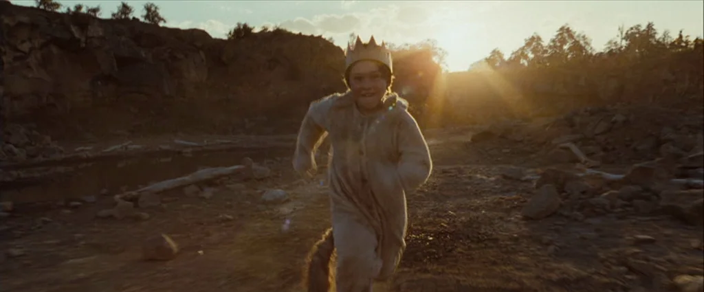 Where The Wild Things Are (2009) movie still: fullbody — A rocky and barren quarry terrain under the late afternoon golden hour sun. A young boy…