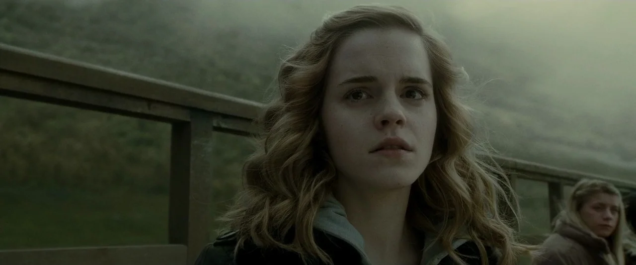 Harry Potter & The Half Blood Prince (2009) movie still: medium — A woman stands on a wooden bridge in a misty, mountainous outdoor environment. She…