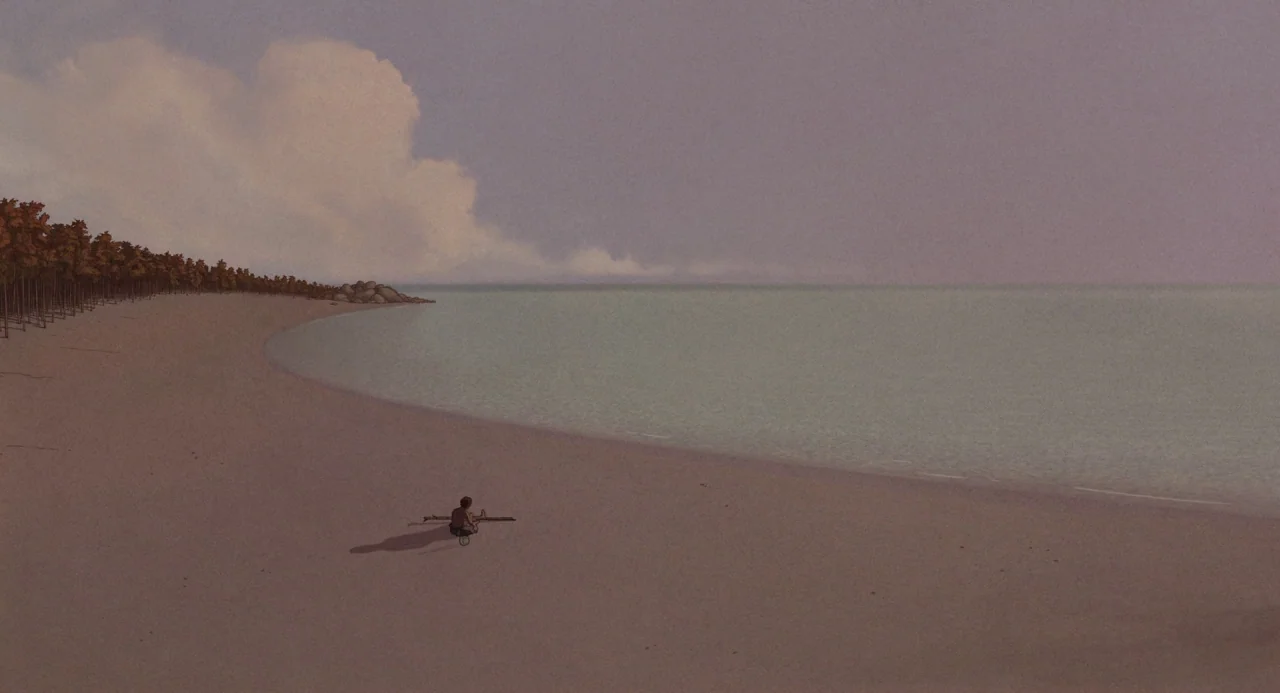 The Red Turtle (2016) movie still: wide — A vast, empty sandy shoreline borders calm water under a muted, overcast sky. A single child sits on the…