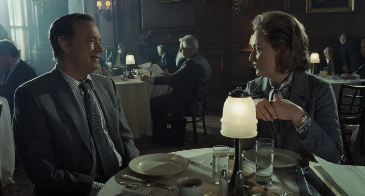 The Post (2017) movie still: medium — An upscale mid-century dining room features dark wood paneling and multiple tables with white cloths. A man…