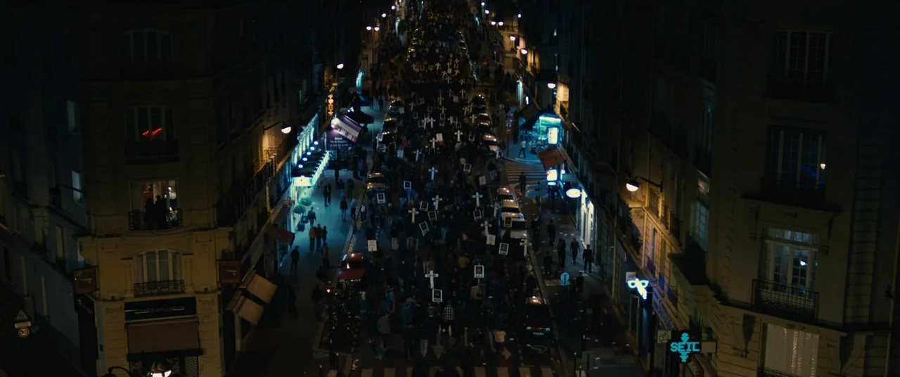 BPM (Beats Per Minute) (2017) movie still: establishing — A dense crowd marches down a European-style city street lined with tall apartment…