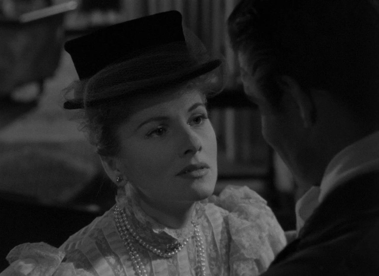 Letter From An Unknown Woman (1948) movie still: closeup — An interior space features a woman in Victorian-style clothing facing a man off-screen.…