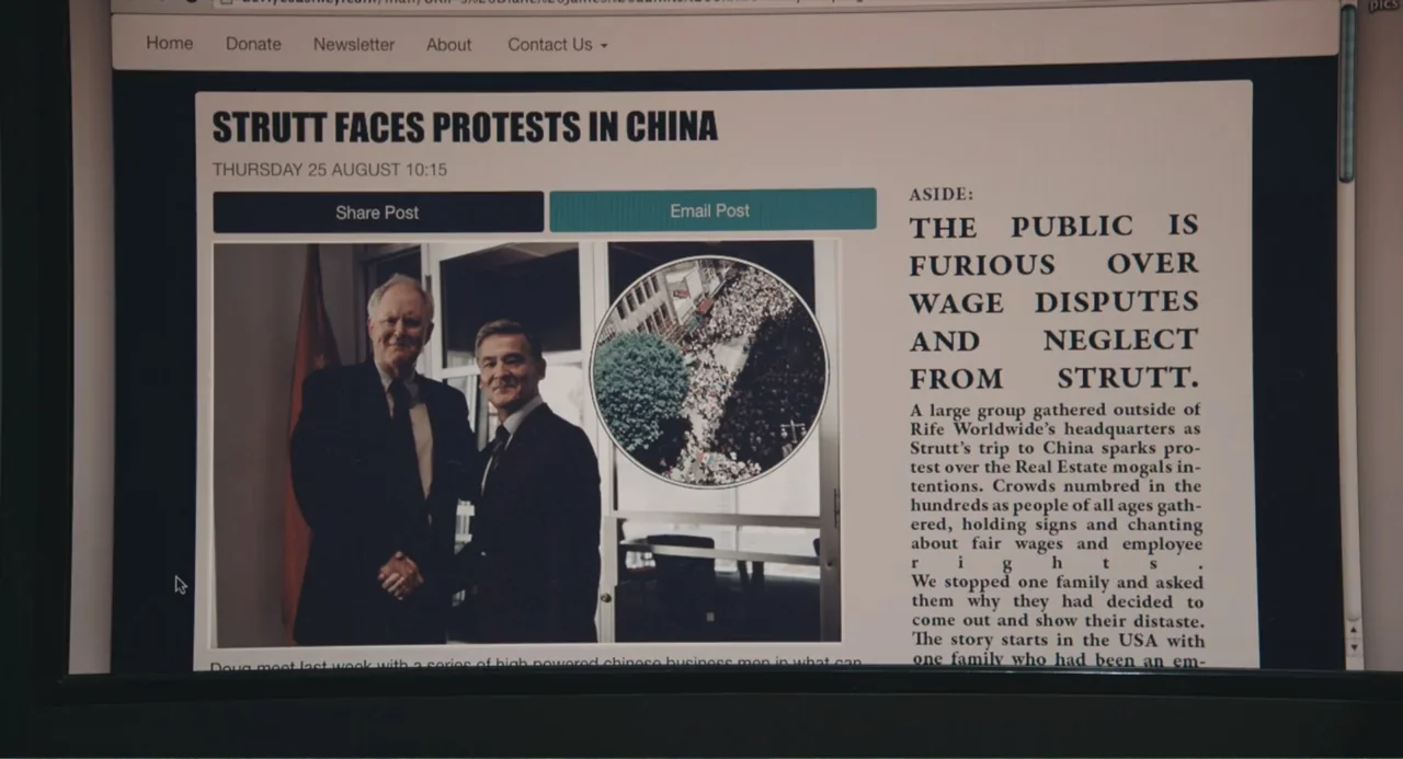 Beatriz at Dinner (2017) movie still: closeup — A computer screen displays a news article titled Strutt Faces Protests in China. The page contains a…