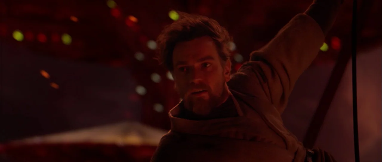 Star Wars: Episode III – Revenge of the Sith (2005) movie still: medium — A man stands in a dark, red-tinted environment filled with volcanic heat…