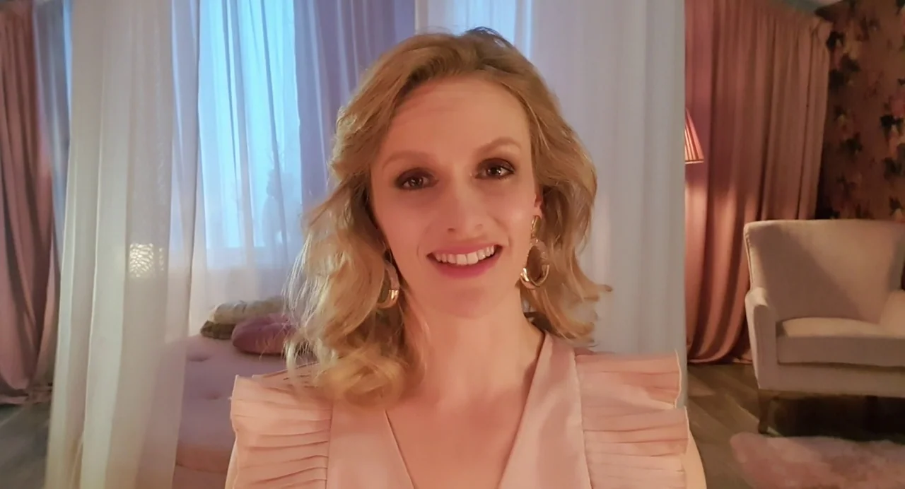Hatching (2022) movie still: closeup — A light-filled room features draped sheer curtains and soft upholstered furniture in pastel tones. A blonde…