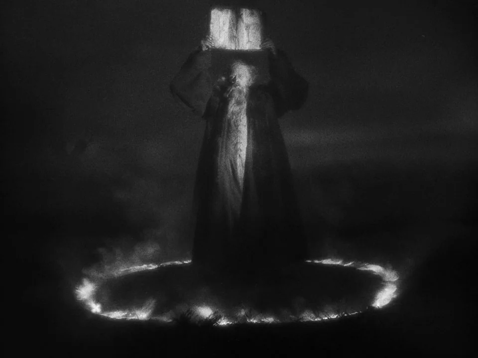 Faust (1926) movie still: fullbody — An elderly man in dark robes stands in a desolate, dark landscape at night. He holds two large stone tablets…