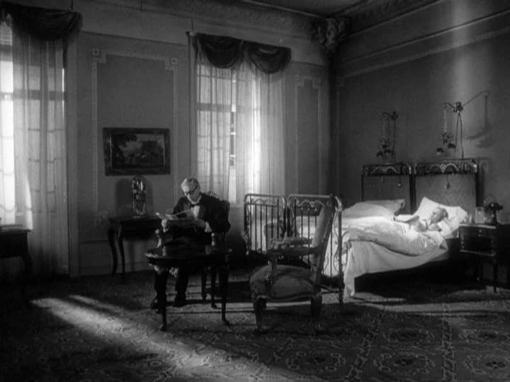 The Silence (1963) movie still: wide — A spacious 1940s hotel suite features patterned carpeting and ornate tall, windowed walls. An elderly man…