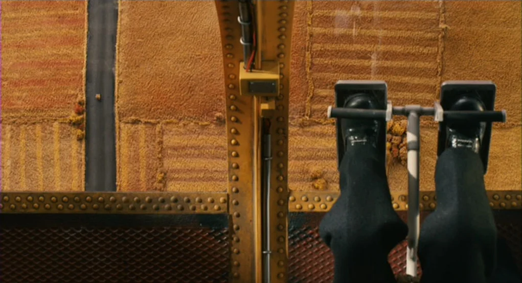 Fantastic Mr. Fox (2009) movie still: medium — A close overhead perspective shows pilot legs operating aircraft rudder pedals inside a cockpit.…