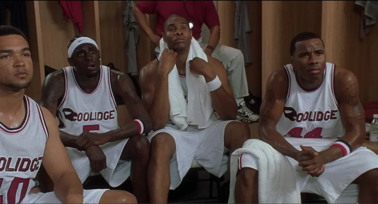 National Lampoon's Van Wilder (2002) movie still: medium — A wooden locker room features rows of lockers and basketball players in matching…