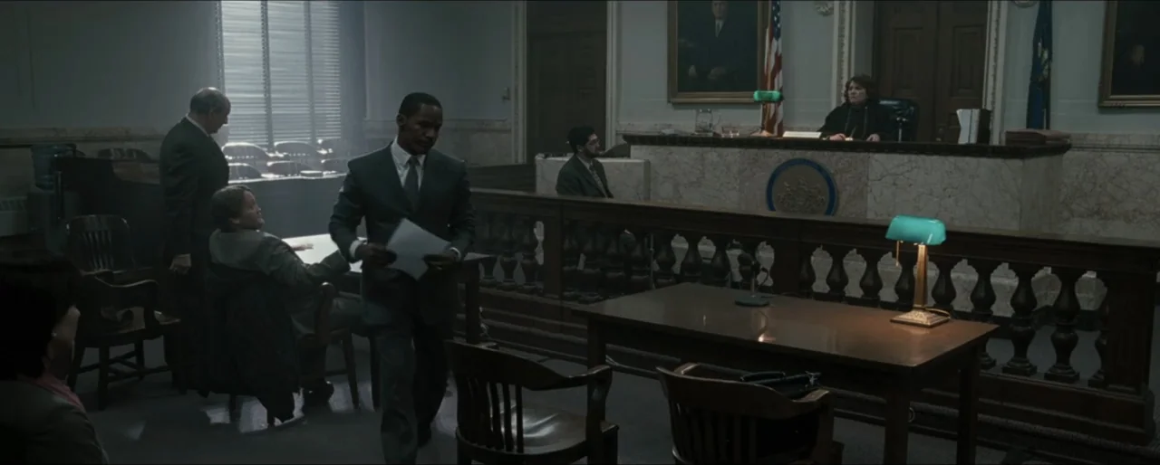 Law Abiding Citizen (2009) movie still: wide — A wood-paneled courtroom interior features formal seating areas, a judge's bench, and large windows.…