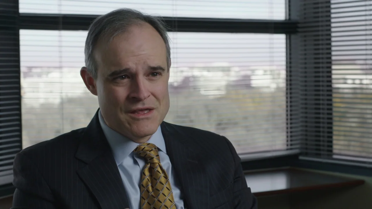 Kill Chain: The Cyber War on America's Elections (2020) movie still: medium — A modern professional interior with large windows covered by…