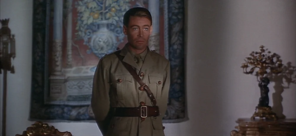 Lawrence Of Arabia movie still: medium — An opulent interior space with a decorative wall tapestry and ornate metal tabletop sculptures. A military…