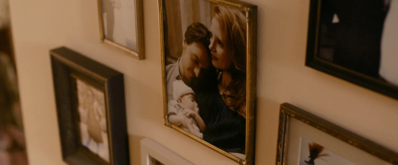 The Disappearance of Eleanor Rigby: Her (2014) movie still: closeup — A wall populated with several framed photographs displayed in a cluster. The…