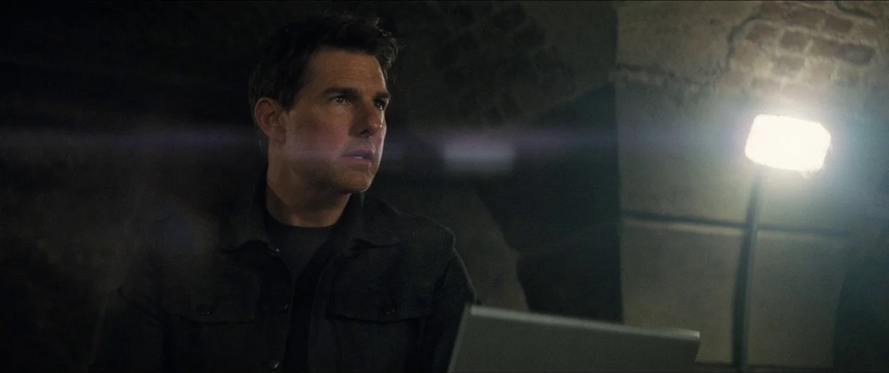 Mission: Impossible – Fallout (2018) movie still: medium — A dimly lit underground chamber with rough stone walls and brickwork visible in the…
