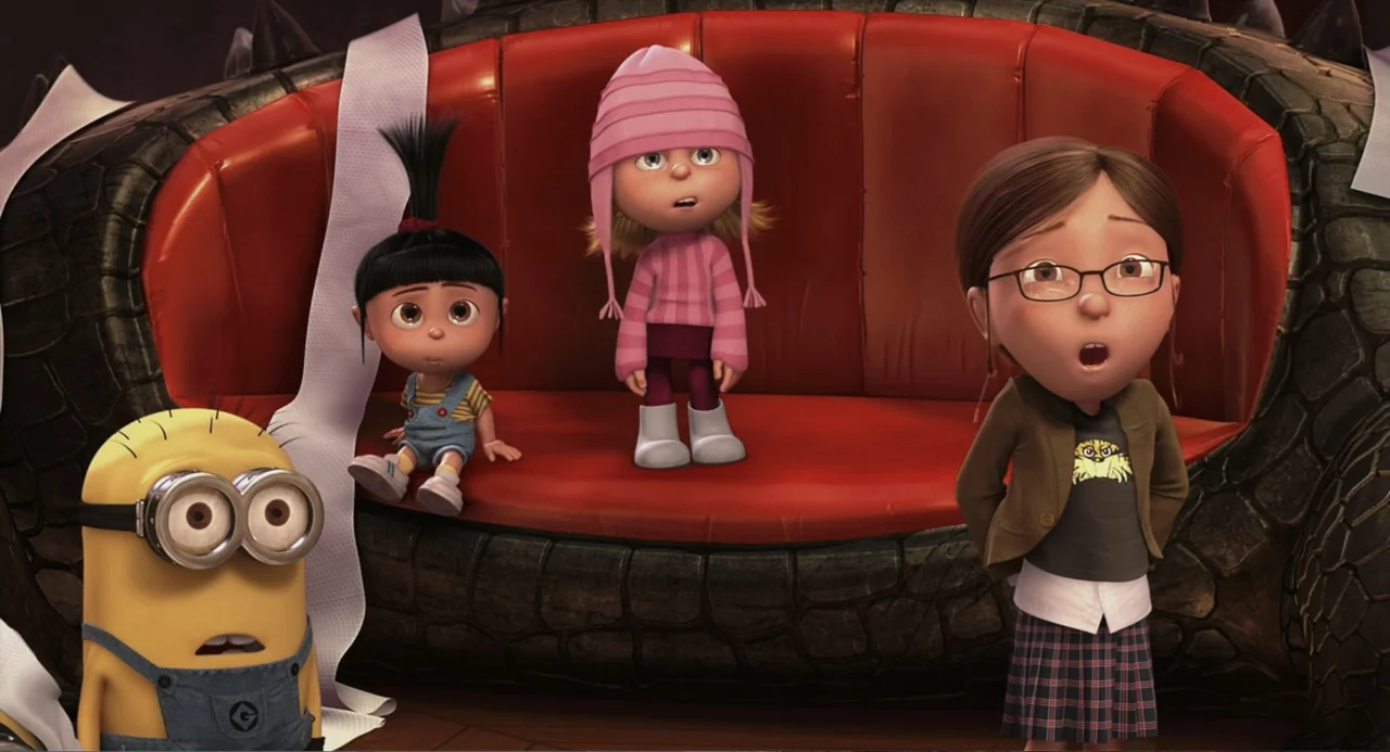 Despicable Me (2010) movie still: medium — A living room features a stylized red sofa with a dark textured base. Three children and one minion…