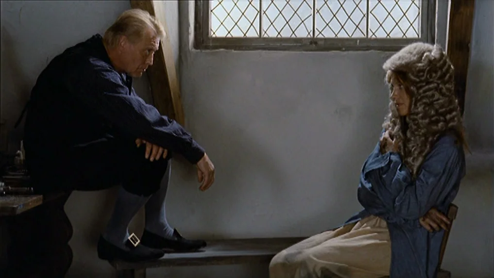 The Scarlet Letter (1973) movie still: medium — An attic with white plaster walls features a single multi-paned window and wooden beams. A man in…