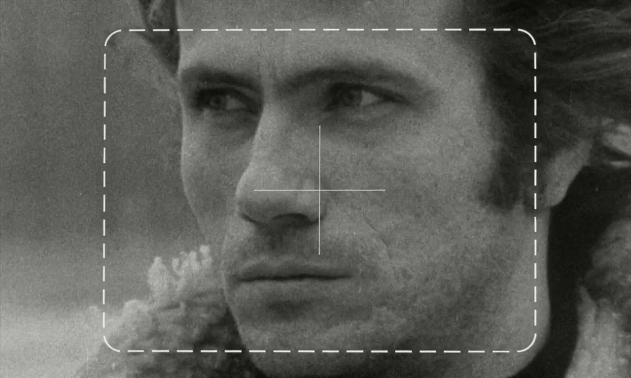 The Lost Honour of Katharina Blum (1975) movie still: closeup — A man with a textured jacket stands outside in a field during the day. He looks…