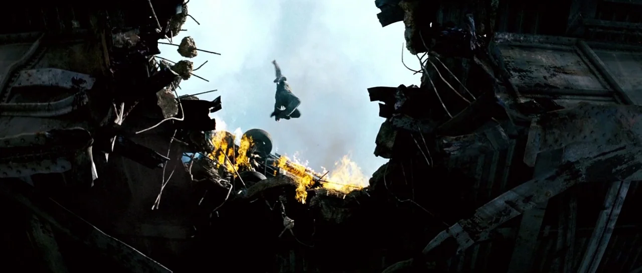 Mission: Impossible III (2006) movie still: wide — A dark, heavily damaged metal bridge structure is torn apart with gaping holes. A single…