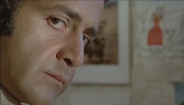 Le Boucher (1970) movie still: closeup — An interior space features off-white walls decorated with small framed drawings and paper art. A…