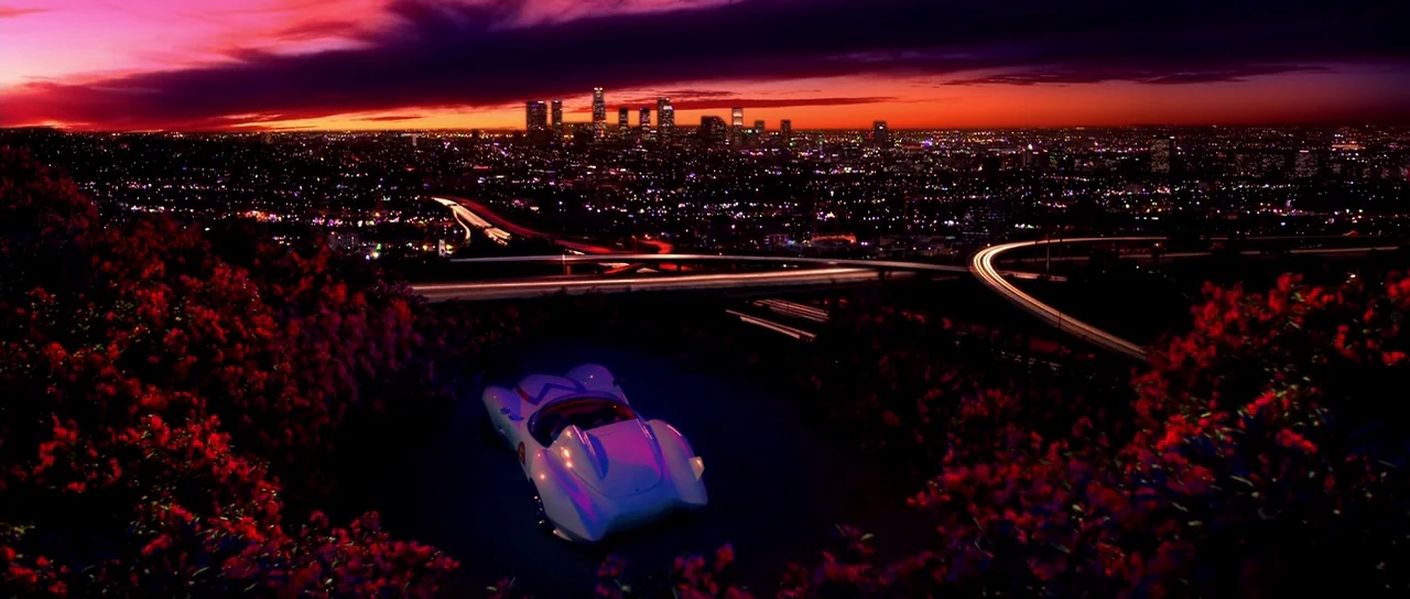 Speed Racer (2008) movie still: wide — A Los Angeles hillside overlook at night features a white sports car parked. The distant sprawling city…