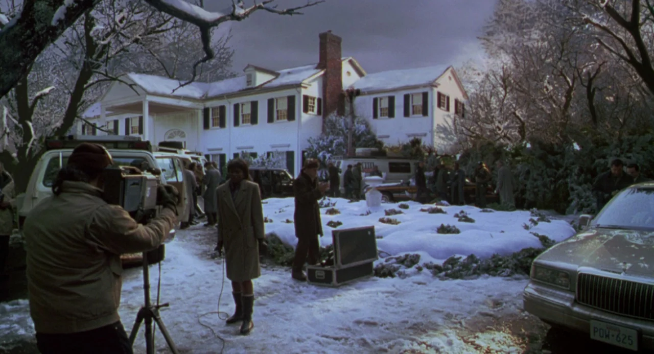 The Birdcage (1996) movie still: wide — A snow-covered lawn sits in front of a large, two-story colonial style house. Several crew members and media…