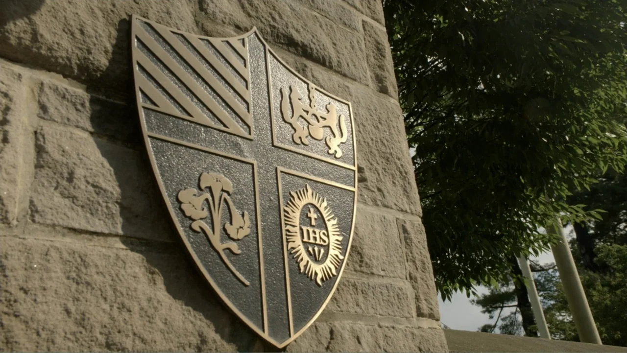 The Day the Music Died: The Story of Don McLean's "American Pie" (2022) movie still: closeup — A dark metal shield emblem is mounted onto a…