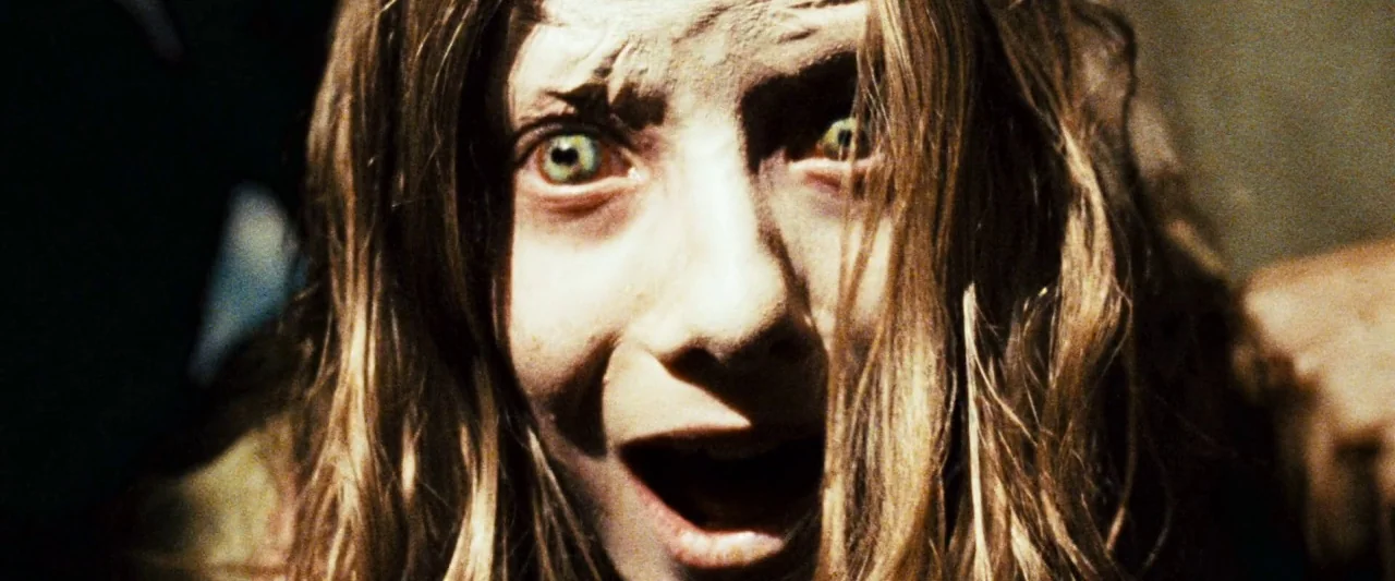 Mirrors (2008) movie still: closeup — A dimly lit, shadowed space frames the subject's face against an obscured background. The girl stares directly…